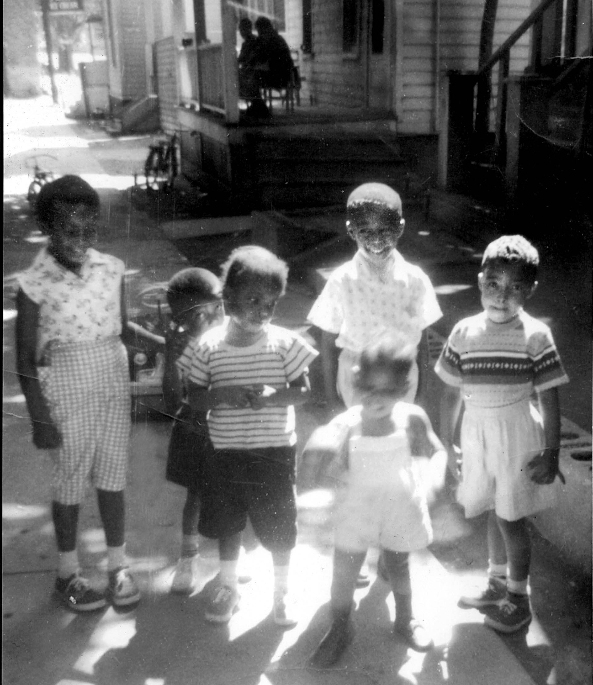 Samuel Roberts (on the right in a striped sweater) with friends and relatives at his childhood home on Rose Ave. — a one block street, down the hill from what would be Upstate University Hospital. Circa 1960.