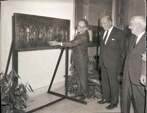 July 1964: Upstate President Carlyle Jake Jacobsen, PhD, discusses the commemorative bronze plaque with colleagues.