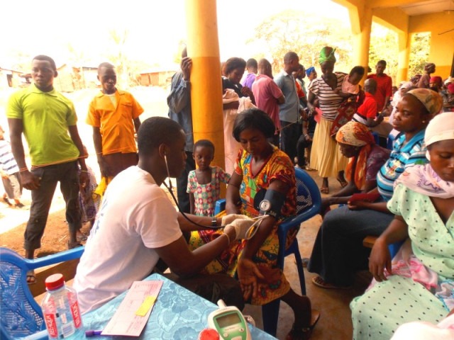 Upstate respiratory therapy student Adlin Noel takes blood pressure at a clinic in Ghana.