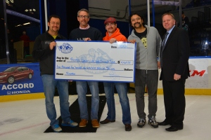 Upstate‘s prostate cancer team helped raise money for prostate cancer research at Upstate Medical University through a Movember Mustache Challenge involving the Syracuse Crunch hockey team. The men grew facial hair throughout the month of November, and fans voted by making online donations which totalled $4,467.58. Participating in the check presentation at the hockey game are, from left, Upstate‘s Gennady Bratslavsky, MD, Michael Lacombe, MD, Dmitriy Nikolovsky, MD, and Srinivas Vourganti, MD. Joining them is Jim Sarosy of the Syracuse Crunch.
