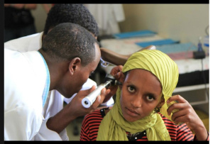 Medical students in the Ethiopian city of Awassa examine a patient using an otoscope donated by Drs. Rick Kelley and Sam Woods, after the Upstate physicians demonstrated how to conduct the exam.