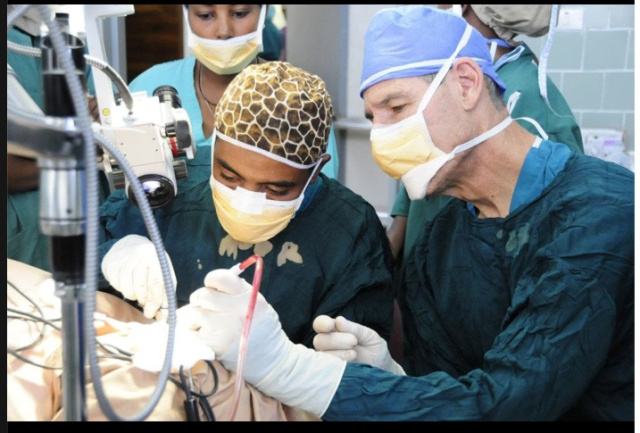 Charles Sam Woods, MD, takes Muluken Bekelle, MD, through an eardrum replacement surgery, called tympanoplasty, in Awassa, a city in Ethiopia.