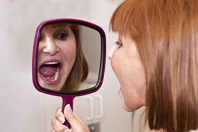 Protect yourself Oral cancer frequently begins as a painless lesion in your mouth. Therefore, experts recommend you carefully examine your mouth on a regular basis for red or white spots, lumps or anything that looks abnormal. Stand in front of a mirror. Using gauze for grip, lift your tongue so you can see beneath and in back of your mouth. Pull your cheeks away from your teeth to get a good look. See your dentist or doctor if you find something unusual. If it‘s affecting your life, and it lasts longer than two weeks, then it requires professional evaluation, advises oral surgeon Terrence Thines, a professor in Upstate University Hospital‘s division of dentistry.