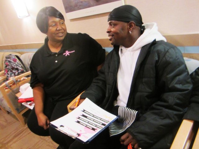 She Matters advocate Martha Chavis-Bonner helps her neighbor, Edward Moody, sign his wife up for a mammogram at the Patricia J. Numann Center for Breast, Endocrine and Plastic Surgery at the Upstate Specialty Services Center. Moody's wife, says Chavis-Bonner, is typical of many African American women: so busy working and taking care of her family that she doesn't take time for her own health.
