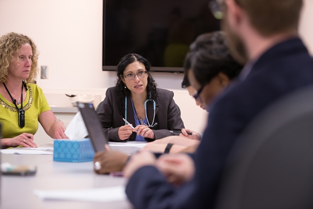 Nearly a dozen caregivers meet to discuss individual patients' care and progress. This meeting is led by Shernaz Hurlong, DO, and attended by additional physicians, nurses, brain injury specialists, physical therapists, occupational therapists, speech language pathologists and a rehabilitative psychologist.