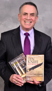 Tony Cerminaro, NP, with two of the murder mysteries he has written.