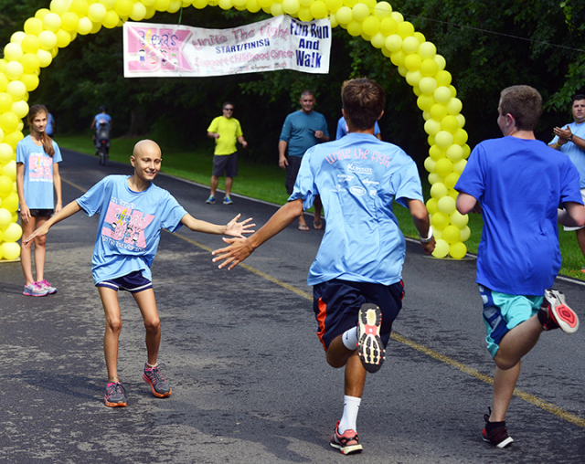Alexa congratulates runners at the 5K run she started to raise money to provide the special towels for children with cancer who are hospitalized at Upstate. (PHOTO BY WILLIAM MUELLER)