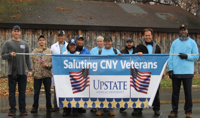 Among the military veterans with ties to Upstate who took part in the Central New York Veterans Parade and Expo at the New York State Fairgrounds on Saturday are (from left, with their service branch): Andrew Brown (College of Health Professions, class of 2017, Marines), Kevin Jacobs (SUNY College of Environmental Science and Forestry student who served in the Marines with Brown), Elton Garvin (CHP, Army), husband and wife Yetta (Sleep Center, Air Force) and Elliott J. Williams (Patient Access Services, Air Force), Ted Spadotto (Physical Plant, Army), Le‘Nard Chisholm (Payroll, Army), T.J. Yount, (CHP class of 2009 alum, Army), Joseph Donovan (Physical Plant, not a veteran, he came to show support) and Willie White (Central Equipment, Army). (PHOTO BY SUSAN KEETER)