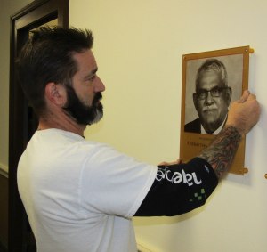 A new plaque of Anesthesiology Chairman Sebastian Thomas, MD, was hung in Weiskotten Hall by Jason Tyre of Image Press.