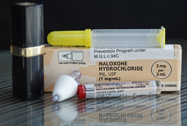 A container of naloxone, which is sold under the brand name Narcan, among others, is shown for scale next to a tube of lipstick. Naloxone is an antidote for opioids. (ASSOCIATED PRESS)