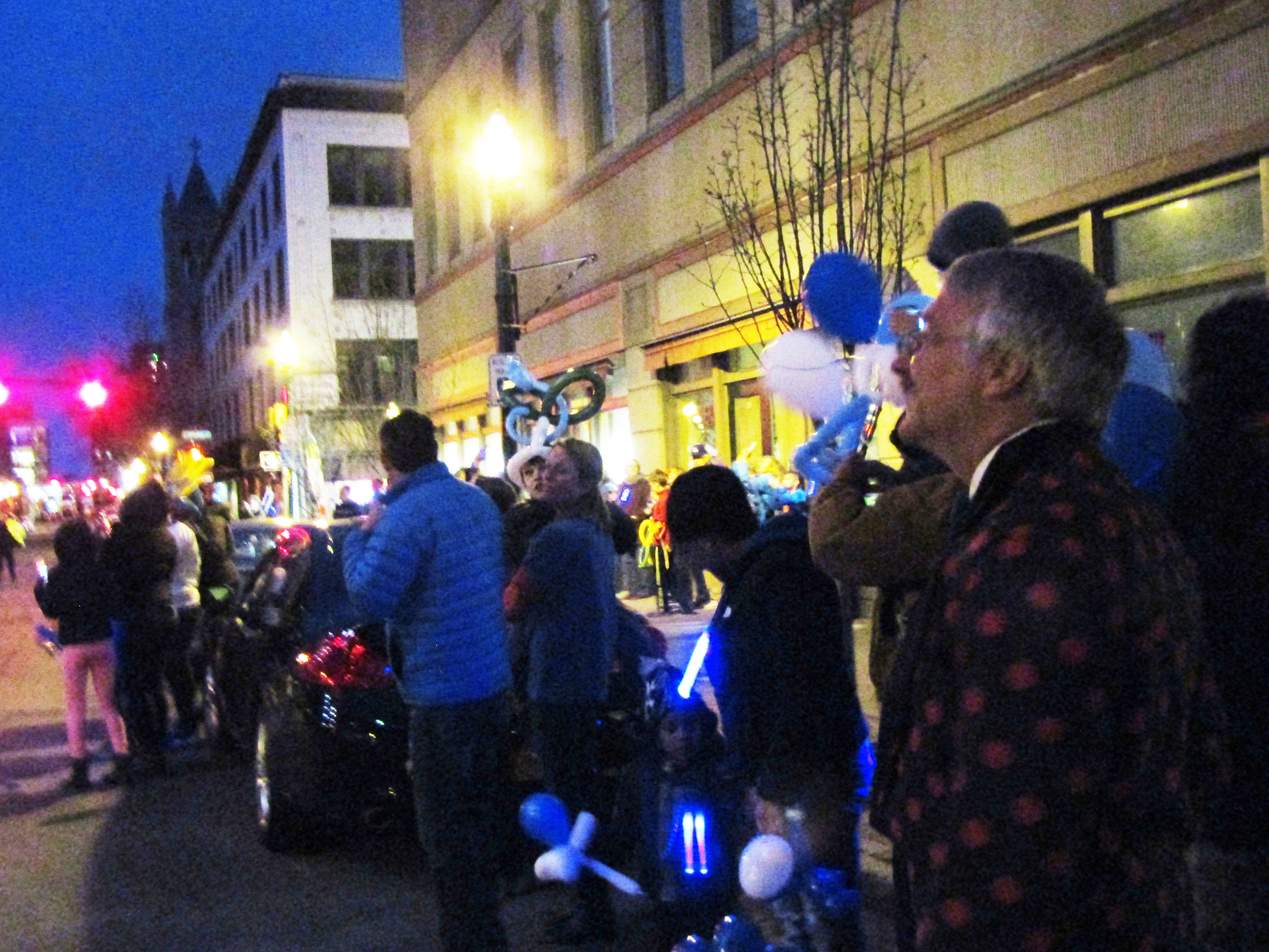 The crowd gathers as Jefferson Tower — and the night sky — light up blue in recognition of autism