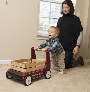 Mason pushes a wooden wagon while his mother, Jesse Campbell, watches. (PHOTO BY SUSAN KAHN)