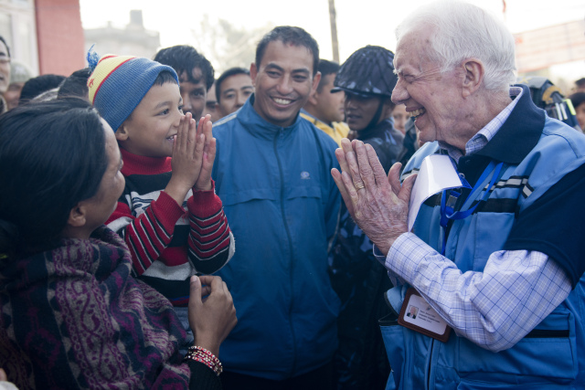 Former President Jimmy Carter greets a Nepalese boy in Kathmandu, Nepal, in November 2013, when the Carter Center monitored Nepal's constituent assembly election, sending observers from 31 countries. (PHOTO BY THE CARTER CENTER)