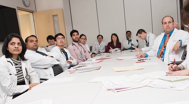 Jason Wallen, MD (right) is medical director of Upstate's Thoracic Oncology Program. Members of the team meet each week to review cases. (PHOTO BY SUSAN KAHN)