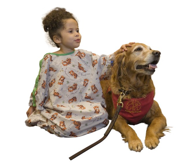 Tymareah Rudolph and Daphne, a therapy dog, in a hospital playroom. (PHOTO BY SUSAN KAHN)