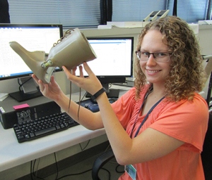 Julia Rogers holds an orthotic device used to help people with progressive flat foot.