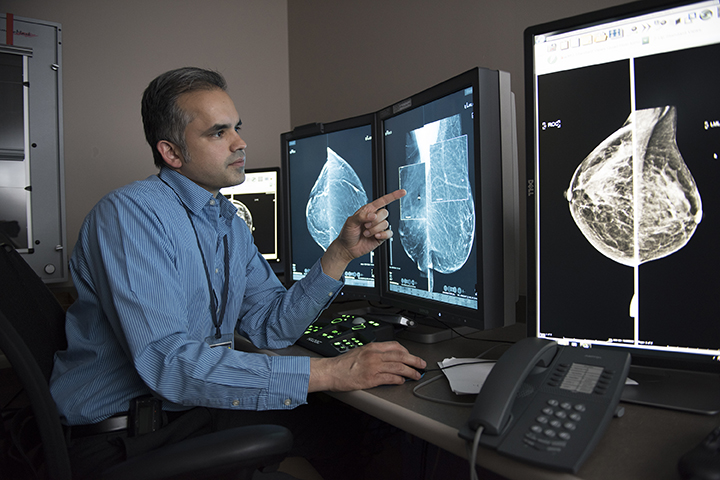 Upstate radiologist Ravi Adhikary, MD, reviews images from a 3-D mammogram. (PHOTO BY SUSAN KAHN)
