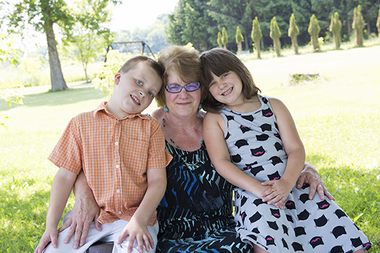 Michelle Shelly Kikta-Kiner, at home with her grandchildren, Cole, 8, and Rowan, 7. (PHOTO BY SUSAN KAHN)