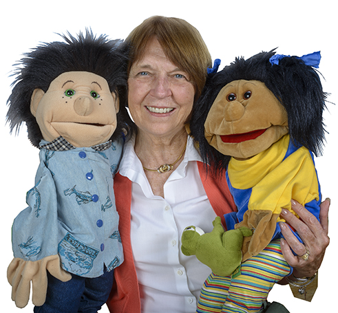 Carroll Grant, PhD, with Carey (left) and Sally, the puppet characters who inspired the book Carey and Sally: Friends With Autism. (PHOTO BY ROBERT MESCAVAGE)