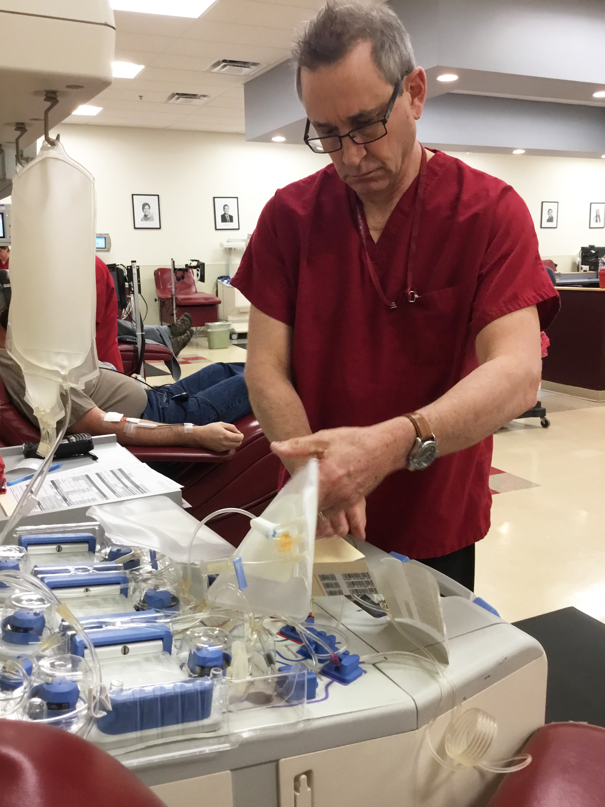Scott Goodrich prepares equipment for a platelet donation at the Red Cross' Liverpool Blood Donation Center. Goodrich is a phlebotomist, someone trained to draw blood from patients. (PHOTO BY SUSAN KEETER)