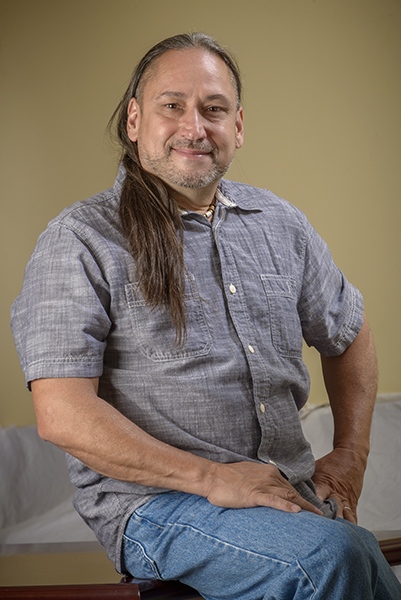 Patrick Young wears a necklace in memory of his mother, who died at age 59 from lung cancer. She taught him to hunt. The necklace is made from antlers of the first deer Young shot, plus wooden and brass beads and a Buffalo nickel pendant carved by a master gunsmith. (PHOTO BY ROBERT MESCAVAGE)