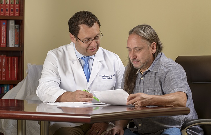 Upstate urologist Gennady Bratslavsky, MD, meets with Young. (PHOTO BY ROBERT MESCAVAGE)