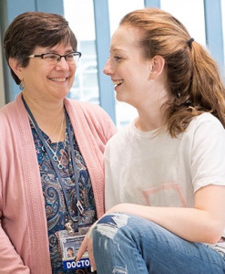 Popular with her oncologist, Melanie Comito, MD. Upstate offers cancer services for adults in Oneida, but children and teens like Popular are treated at the main Upstate campus in Syracuse. (PHOTO BY SUSAN KAHN)