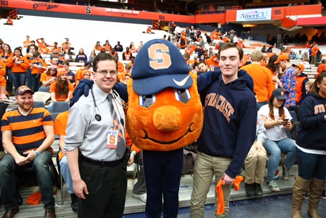 Upstate emergency physician Christopher Tanski poses with Otto the Orange and SU student Alex McMillan, who was revived when his heart stopped during the basketball game on Feb. 4. Photo by Mike Okoniewski/Syracuse Athletics
