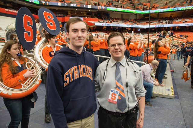 Syracuse University student Alex McMillan posed one month later with the Upstate emergency physician who helped save his life during an SU basketball game Feb. 4. Photo by Michael J. Okoniewski/Syracuse Athletics.