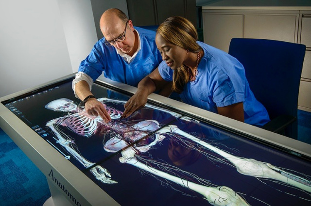 Sam Carello, director of laboratory informatics at Upstate, and nurse practitioner Bridget McCarthy are shown using the anatomize table.