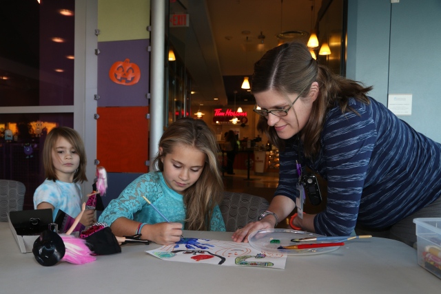Siblings of patients, such as these girls working with art therapist Maria Fazzini, can also take part in art therapy. When Fazzini hosts art gatherings in the hospital's performance center, they are designed for both the patient and his or her family, as a chance to get out of the patient's room, relieve stress and have fun.
