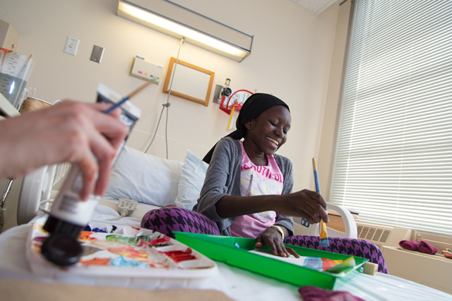 Zenabou, 17, enjoys an art therapy session during her recovery from spinal surgery to treat scoliosis at the Upstate Golisano Children's Hospital. (PHOTOS BY KATHLEEN PAICE FROIO)