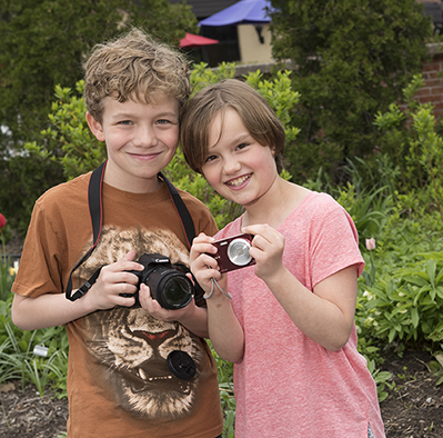 Ashton and Jordan Miller at the Rosamond Gifford Zoo at Burnet Park in Syracuse. They like to photograph animals and have raised money for the zoo's Adopt an Animal program. (PHOTO BY SUSAN KAHN)