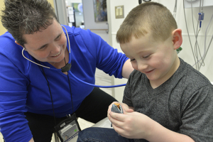 At the same checkup session, pediatric oncologist Andrea Dvorak, MD, checks Greyson's heart rate and lung function.