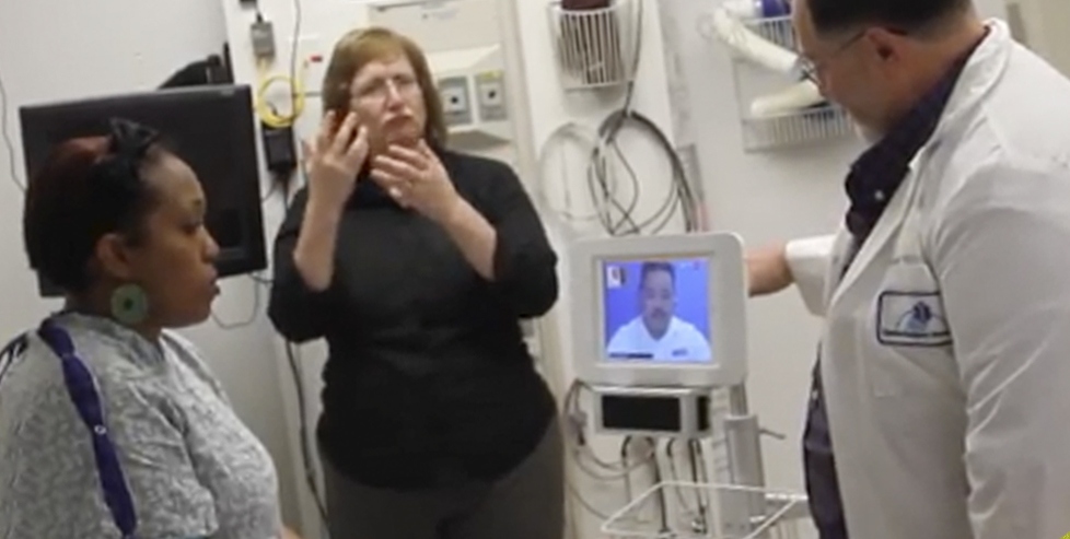 Sue Freeman, center, communicates via American sign language in an instructional video demonstrating the interpreting services available at Upstate. Also appearing are Upstate employees Priscilla Santana, left, and Rod Freeman, right. English, Spanish and ASL versions of the video can be found on Upstate's YouTube channel.