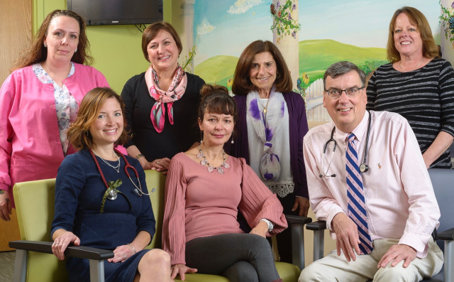 The pediatric rheumatology team at Upstate: standing, from left, are medical assistant Kelley Baker, nurse Vickie Keeler and administrative assistants Kathy Messina and Rebecca Wisnowski. Seated, from left, are Caitlin Sgarlat Deluca, DO, nurse Dori Brier and William Hannan, MD. (PHOTO BY ROBERT MESCAVAGE)