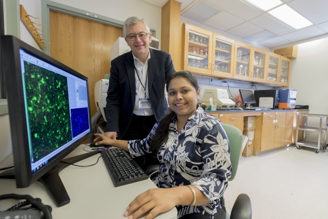 Leszek Kotula, MD, PhD, standing, with doctoral student Disharee Das. (PHOTO BY SUSAN KEETER)