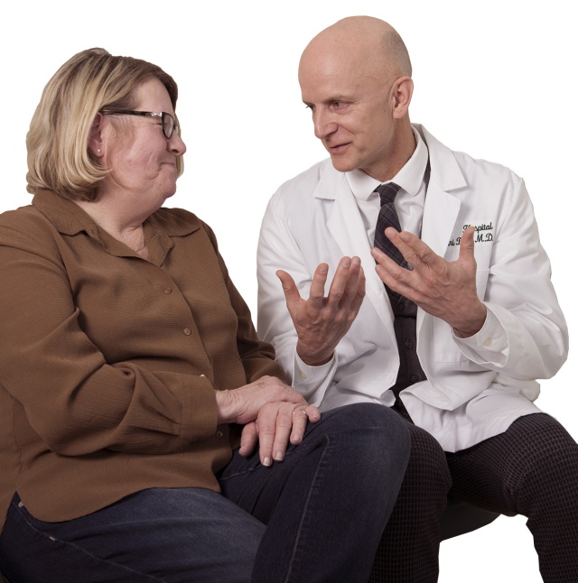 Colorectal surgeon Jiri Bem, MD, talks with his patient Billie Downey. Downey has follow-up appointments with him close to her home in Clayton. (photo by Susan Kahn)