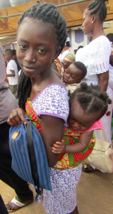 A young woman holds the Days for Girls reusable cloth menstrual kit she received at an ASAP presentation for street women in Kumasi, Ghana. (PHOTO BY SUSAN KEETER)