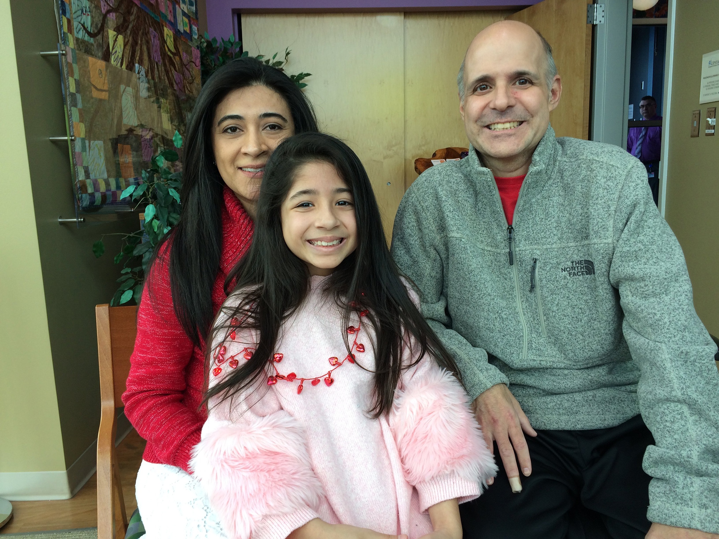 Marcela and Robert Crain with their daughter, Isabella, 8, in the chapel at Upstate University Hospital on Feb. 14, when he was discharged.(Photo by Elizabeth Doran/Syracuse Media Group)