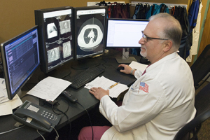 Karmel reviews a CT scan of a chest to evaluate whether fluid around the lung needs to be drained. (photo by Richard Whelsky)