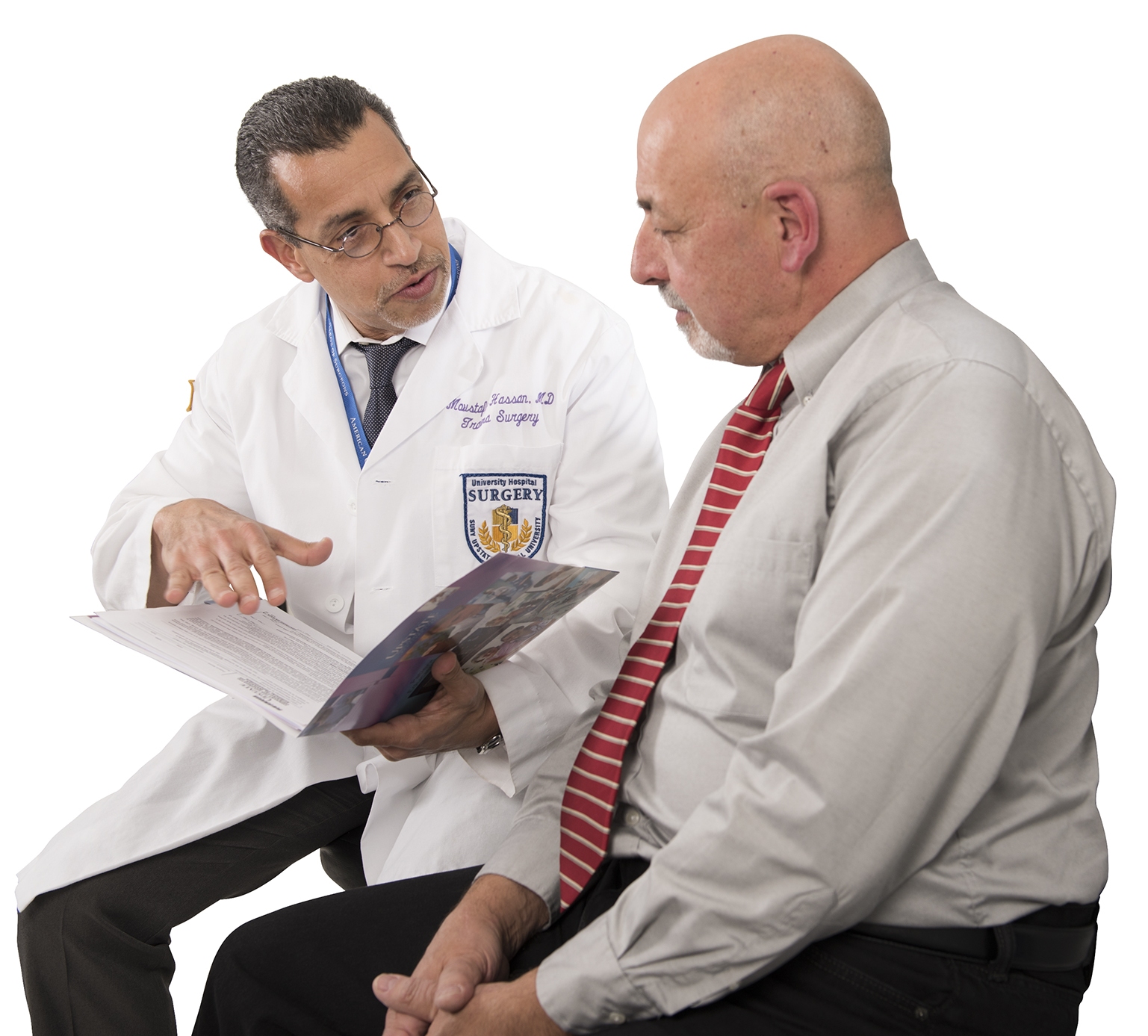 Moustafa Hassan, MD, talks with his patient Peter Corigliano, who has made a profound recovery after being severely injured in an industrial accident. (photo by Susan Kahn)