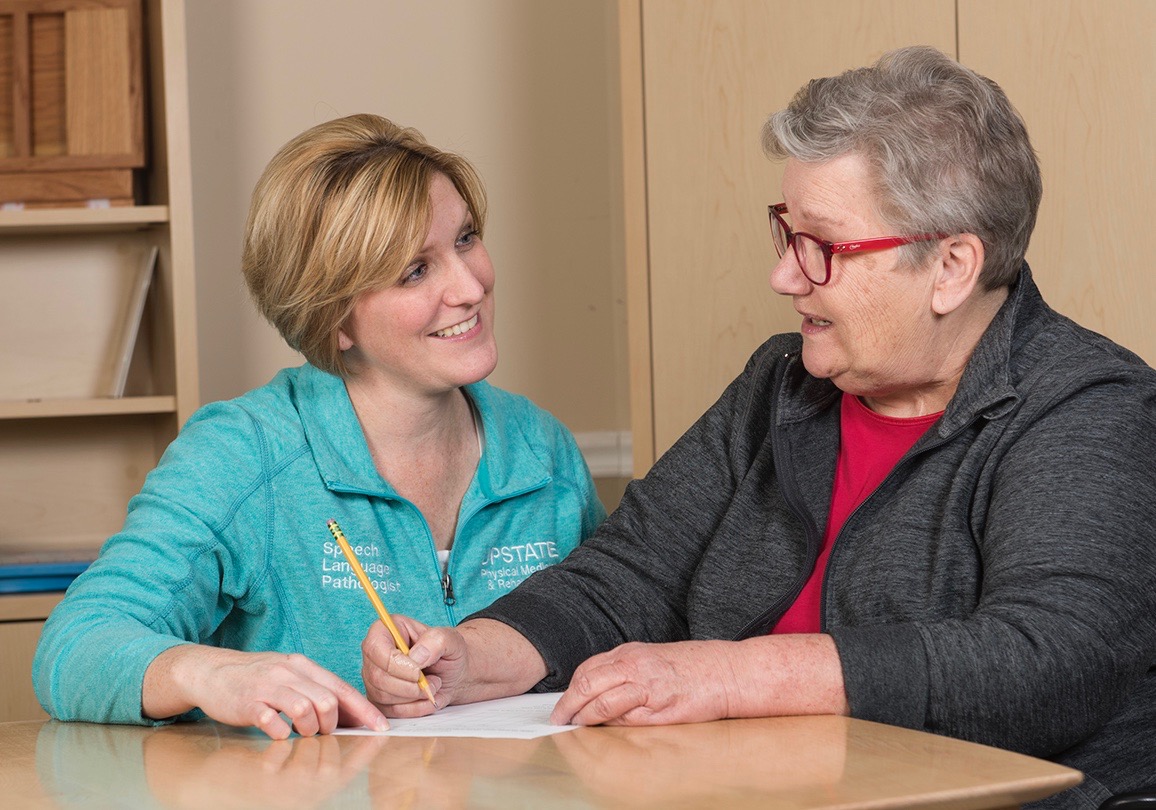 Speech-language pathologist Carrie Garcia, left, works with stroke survivor Eileen Rosecrants. (photo by Susan Kahn)
