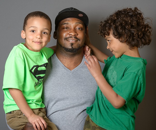 Theron Blair of Baldwinsville with his sons Tyler, 5 (left), and Trey, 7. Chemotherapy left Trey bald for a while, and now that his hair is growing back, he's not cutting it. Now, Trey has daily oral chemotherapy medication and sees pediatric oncologist Andrea Dvorak, MD, and nurse Yvonne Dolce monthly at the Upstate Cancer Center. (photo by Robert Mescavage)