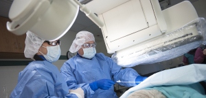 Karmel places a nephrostomy tube in a patient with blocked drainage of the kidney while a fourth-year medical student observes. (photo by Susan Kahn)
