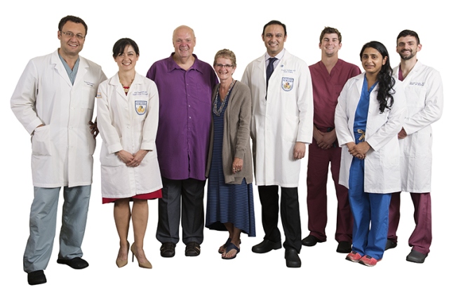 From left: Urology chair Gennady Bratslavsky, MD, trauma surgeon Lucy Ruangvoravat, MD, patient Patrick Graham, Graham‘s wife, Margery Lipinski-Graham, plastic surgeon Prashant Upadhyaya, MD, and urology residents Jeffrey Spencer, MD, Priyanka Kancherla, MD, and Garrett Smith, MD. (photo by Susan Kahn)