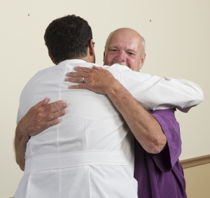 Gennady Bratslavsky, MD, and Graham greet each other at the Urology Outpatient Center at Upstate's Specialty Services Center, 550 Harrison St., Syracuse.