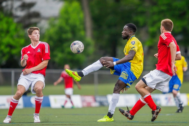 Kissi, seen here in a yellow jersey, says soccer offers a good way to stay fit and deal with stress.