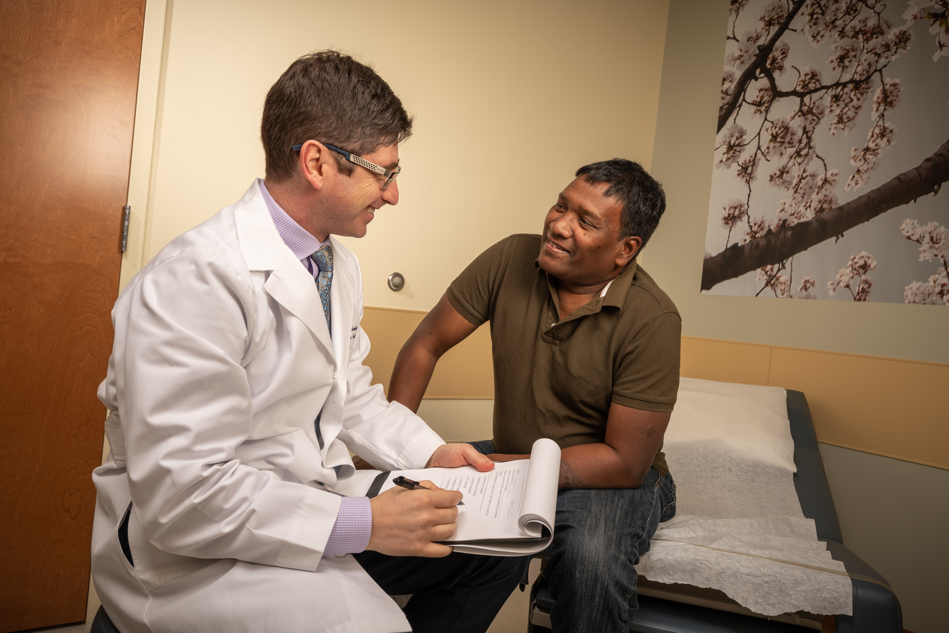 Urologist Dmitriy Nikolavsky, MD, left, and Hemant Tandi at an appointment. (photo by Robert Mescavage)