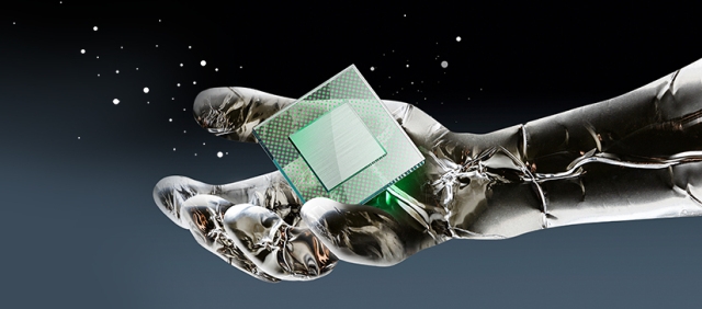metallic robotic hand grasping a CPU